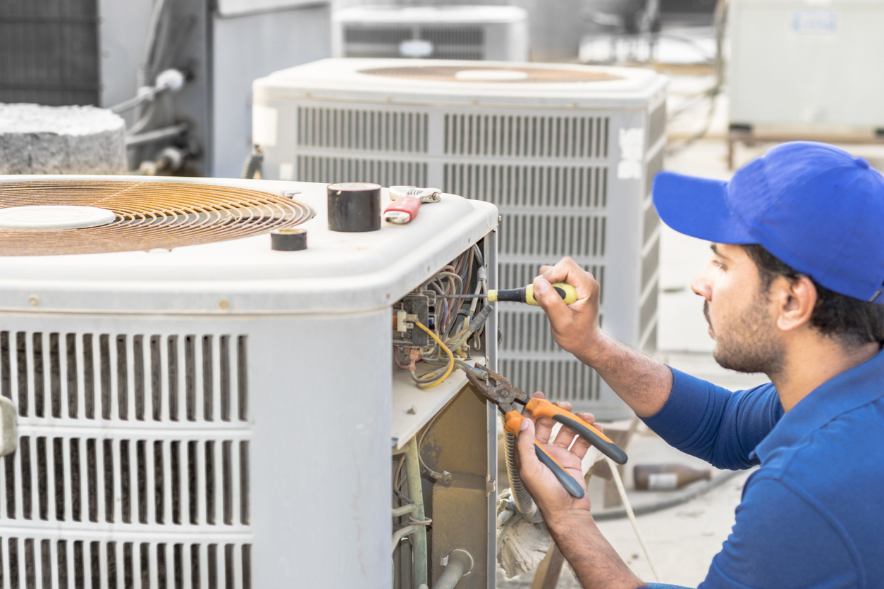 Technician Checking AC Unit